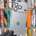 A silver smartphone case with a built-in magnetic card reader, shown fitted on a phone held by a gloved hand. The background is a blurred bookshelf.